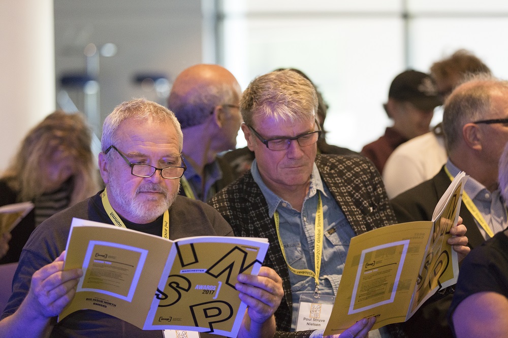 Street paper delegates browse this year's Awards programme as they wait for the ceremony to commence. Credit: Rebecca Lupton