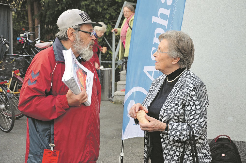 An Asphalt vendor talks to an open day attendee