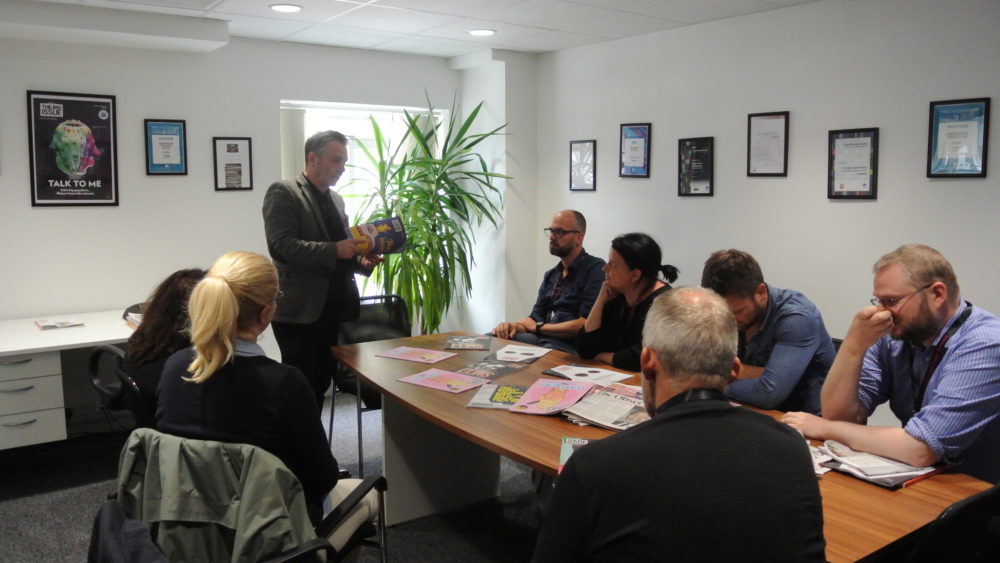 Big Issue editor Paul McNamee talks to one of the summit arrivals day groups on a visit to the Big Issue office