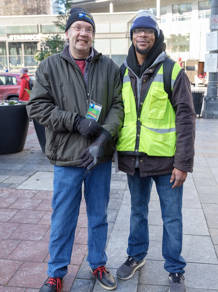 Founding Director of Real Change Tim Harris sold copies of the Seattle street paper during #VendorWeek 2019 while being paired with veteran vendor Michael Dotts. (Credit: Jeff Few)