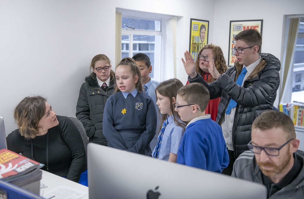 Pupils from a handful of school social enterprises (Bellahouston Academy, Mary Russell School, Pirie Park Primary School and St Joseph’s Primary School) stop by the Big Issue editorial office to present their businesses, learn about the magazine and try their hands at editing the magazine. (Credit: Jamie McFadyen)