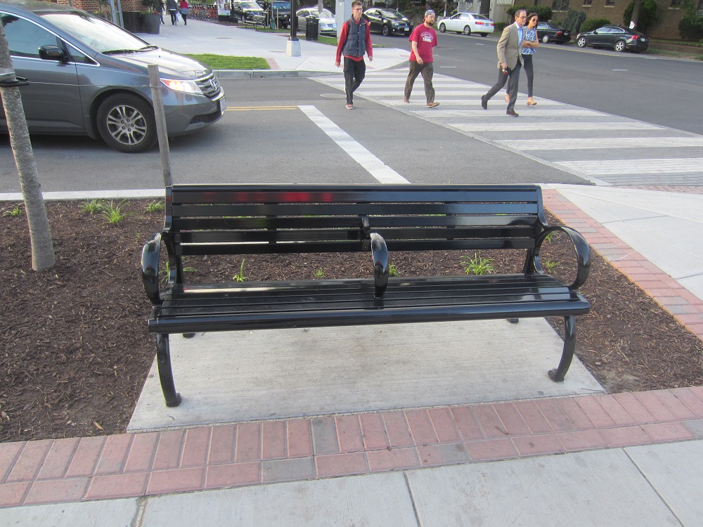 Dividers built in to what benches remain in the city prevent anyone from stretching out and lying down comfortably.. [Credit: Ken Martin]