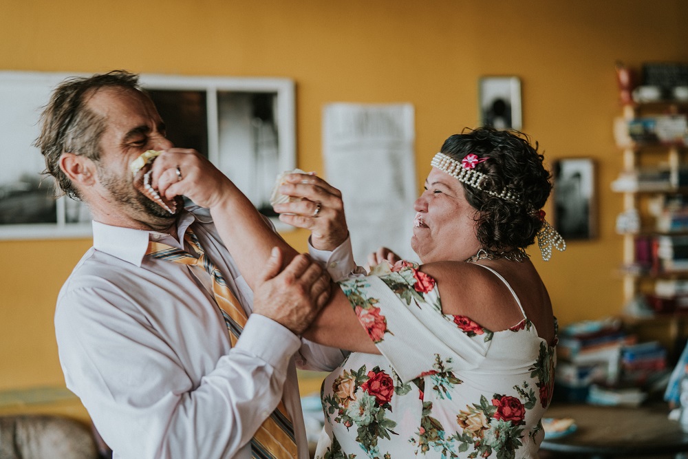 After cutting their cupcakes, Mark and Rene have a little fun with a cake smash. The pair started working with The Curbside Chronicle in 2018. (Credit: Ben Birdwell)