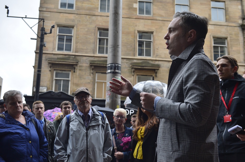 Big Issue Scotland Editor Paul McNamee speaks to a vigil to Big Issue vendor Paul Kelly outside Sainsbury's Buchanan Street. (Credit: Jamie Simpson/Herald & Times)