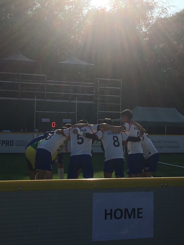 The Korean Homeless World Cup team in a pre-match huddle.