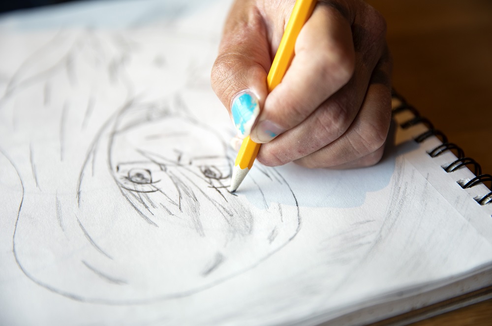 Rin adds details to a recent sketch. She also has a passion for graphic design, computer animation and video games. [Credit: Nathan Poppe]