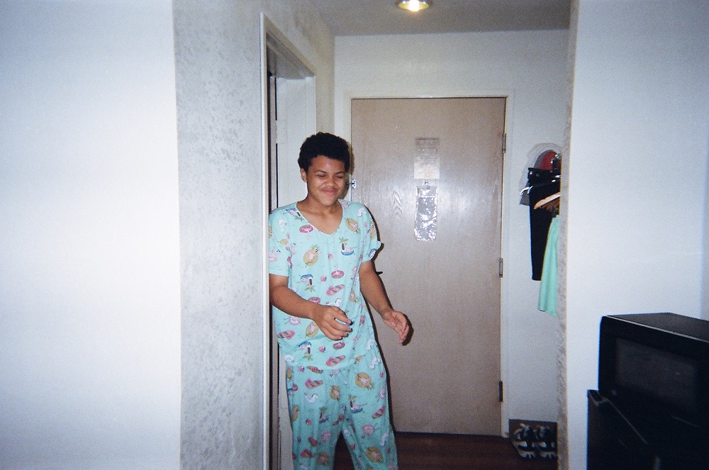 Rion, Delaine’s son, shows off a set of cozy pajamas in the family’s motel room.