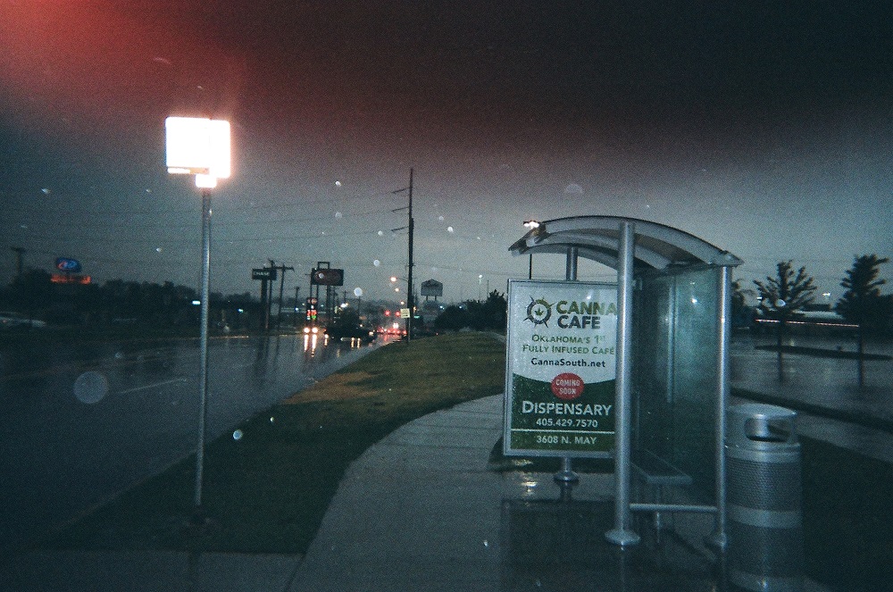 Early morning rain at a bus stop.