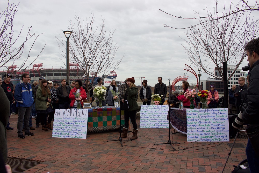Pictures and flowers honor people who died while homeless in Nashville in 2019. [Credit: Hannah Herner]