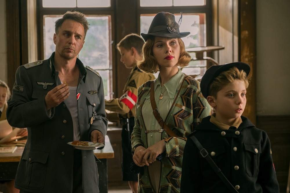 (L-R) Sam Rockwell, Scarlett Johansson and Roman Griffin Davis in Jojo Rabbit. [Photo by Larry Horricks]