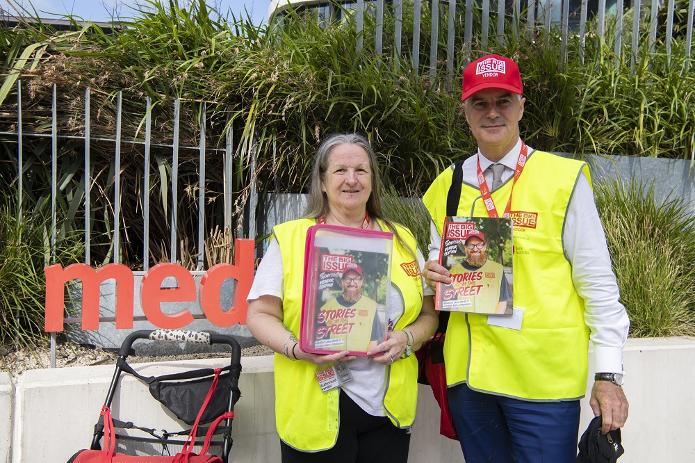 Big Issue Australia vendor Cheryl selling with Medibank CEO Craig Drummond. [Credit: Mark Avellino]