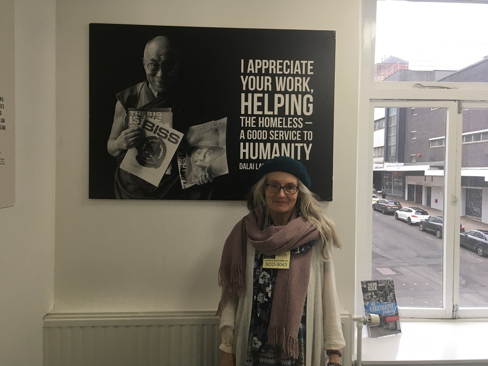 Anabel poses with a poster of the Dalai Lama.