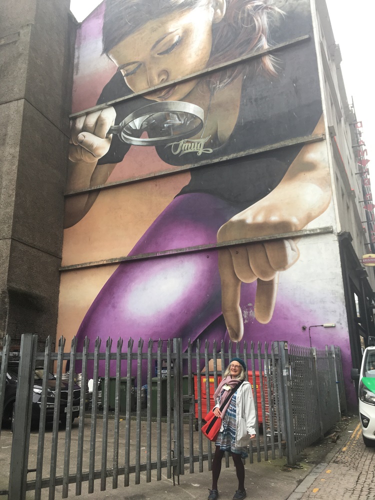 Anabel asked that we take a picture of her at the foot of her favourite Glasgow mural. Artwork like this is scattered across the city. Anabel likes this particular one as the woman depicted reminds her of her daughter.