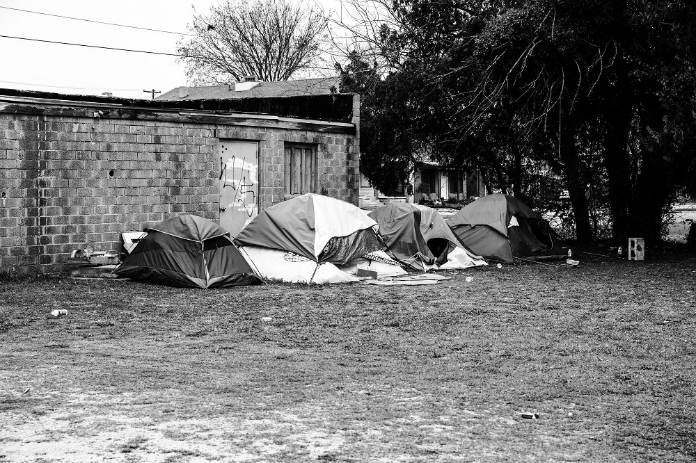 A small tent camp sits behind an empty Oklahoma City business on April 2, 2020. An outreach team dropped off meals to help feed the camp. [Credit: Nathan Poppe]