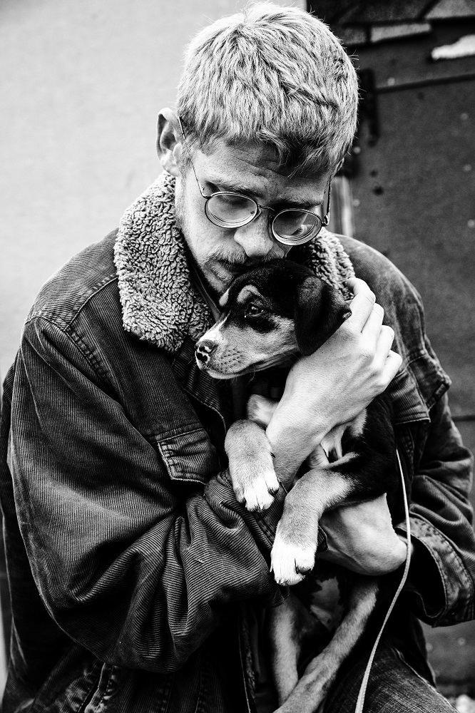 Colton holds his adopted dog, Pepper, which he started taking care of early in the pandemic. [Credit: Nathan Poppe]