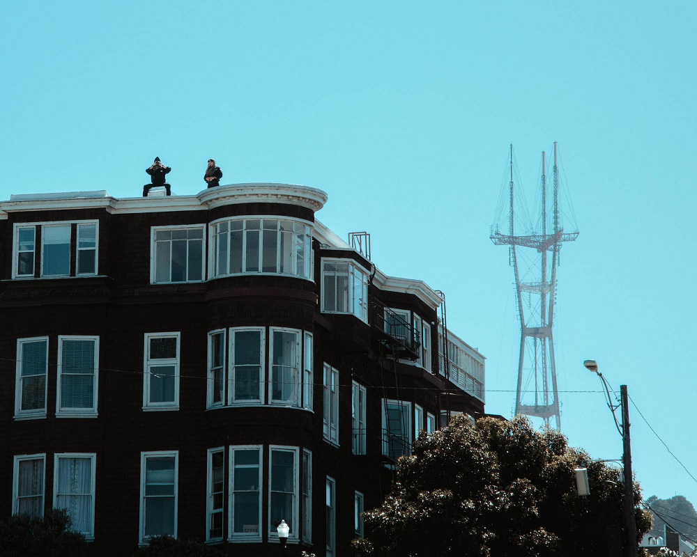 From the roof of a building overlooking Dolores Park, police observe the growing protest gathering outside Mission High School. [Credit: Kit Castagne]