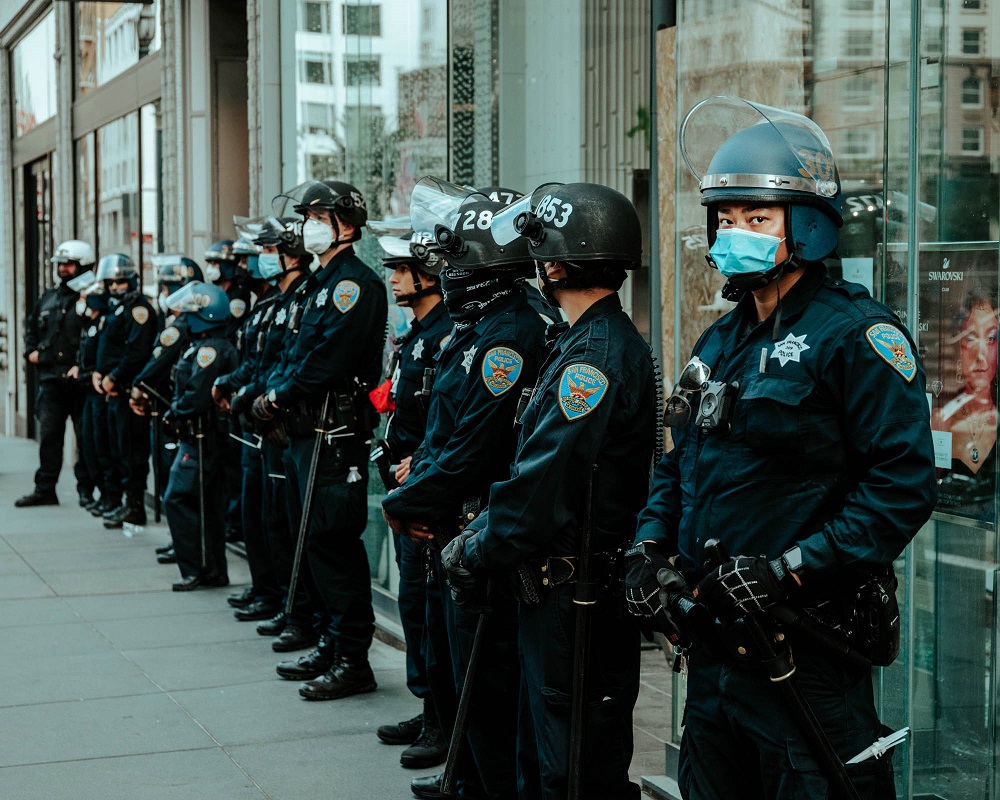 Police line up in front of the Swarovski store in Union Square. The store had been looted the night before. [Credit: Kit Castagne]