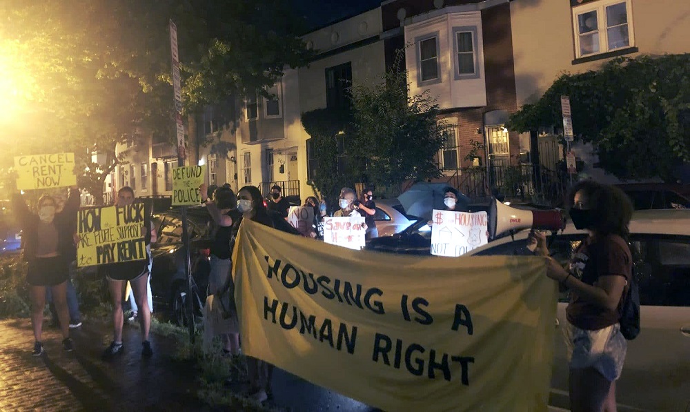 Protesters hold signs, chant, and make noise outside of Anita Bonds' home in D.C., on Tuesday, July 21, 2020. Anita Bonds is chair the D.C. Council Committee on Housing and Neighborhood Revitalization. Protestors called on her and the council to cancel rent for D.C. residents. Photo by Maria Trovato / Street Sense Media.