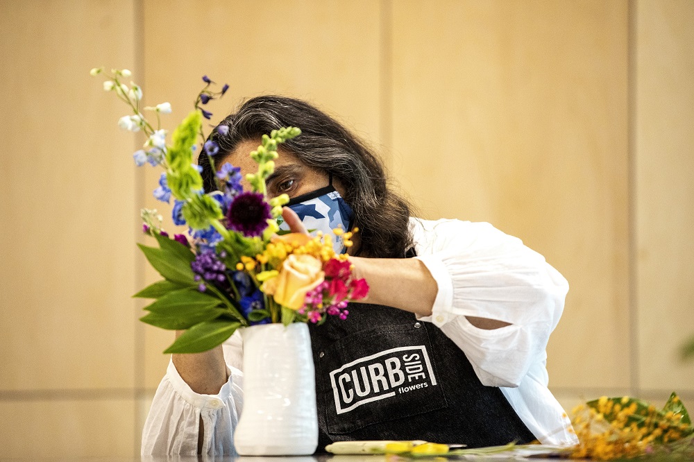 Sonya works on a bouquet on the opening day of Curbside Flowers. [Credit: Nathan Poppe, The Curbside Chronicle]