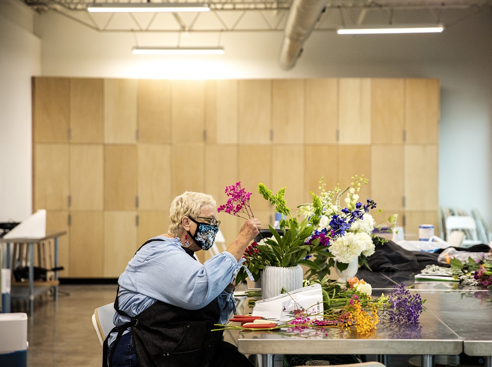 Marsha works on a bouquet on the opening day of Curbside Flowers. [Credit: Nathan Poppe, The Curbside Chronicle]