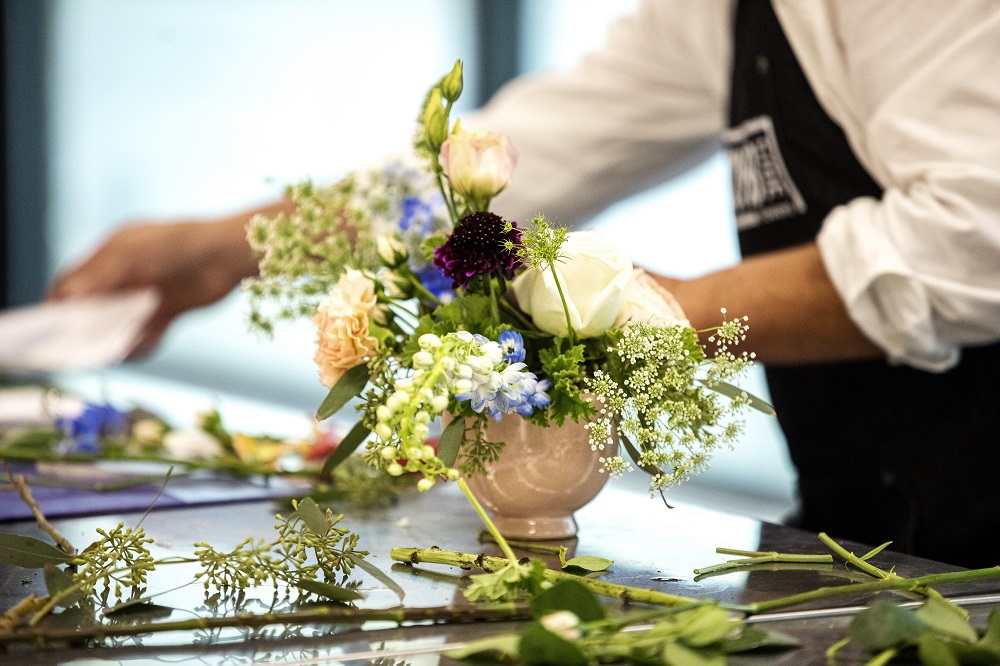 Gary works on a bouquet on the opening day of Curbside Flowers. [Credit: Nathan Poppe, The Curbside Chronicle]