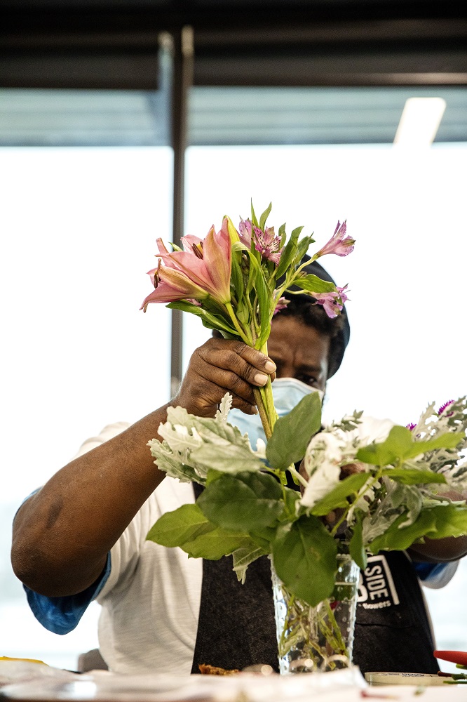 Corey working on a bouquet. [Credit: Nathan Poppe, The Curbside Chronicle]