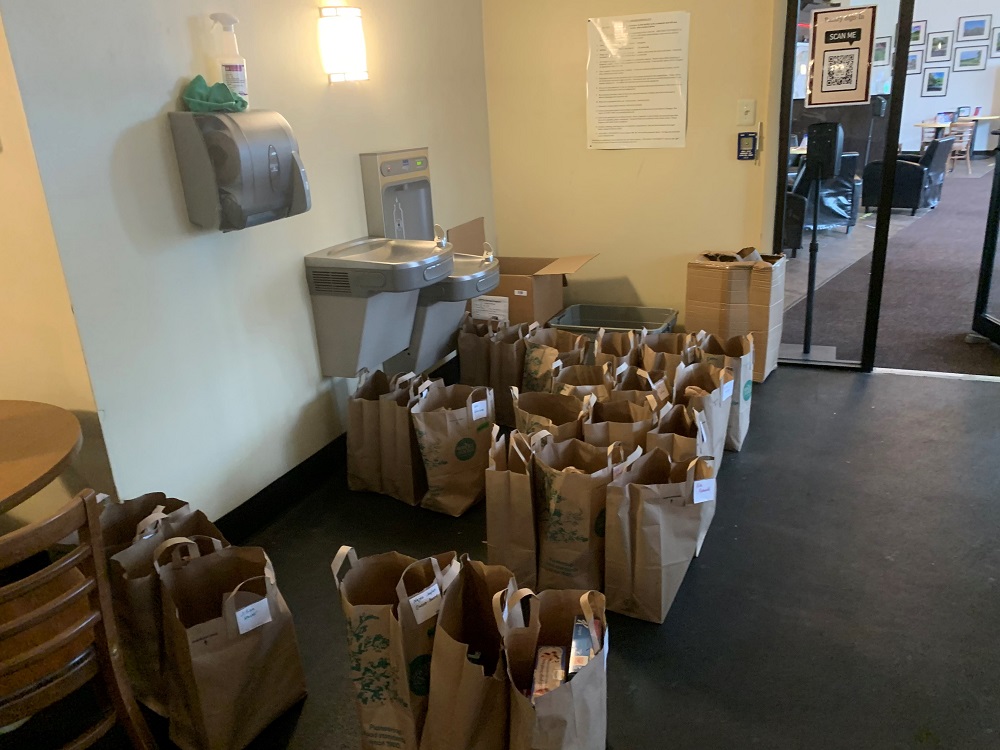 The students have the options to pick up pre-stocked bags of groceries.