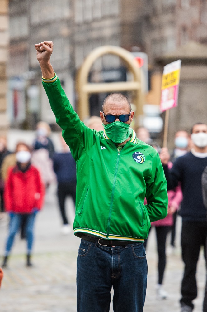 People participating in the 'Take a Knee for George' demonstration, outside St Giles Cathedral in Edinburgh. The demonstration was organised by Stand Up To Racism. Credit: Wullie Marr Photography