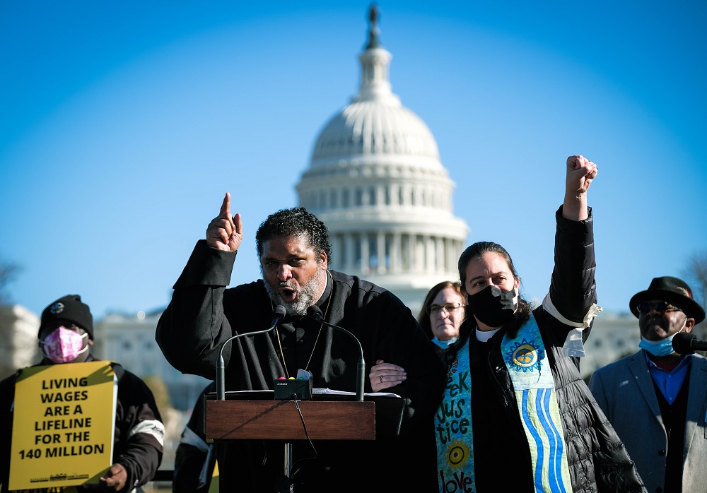 The co-chairs of the Poor People's Campaign: A National Call for Moral Revival, Bishop William J. Barber II and Rev. Dr. Liz Theoharis. The photo was taken Dec. 13, 2021 in Washington, DC, at a Moral March on Washington. Credit: Steve Pavey/Poor People's Campaign/Repairers of the Breach/Kairos Center